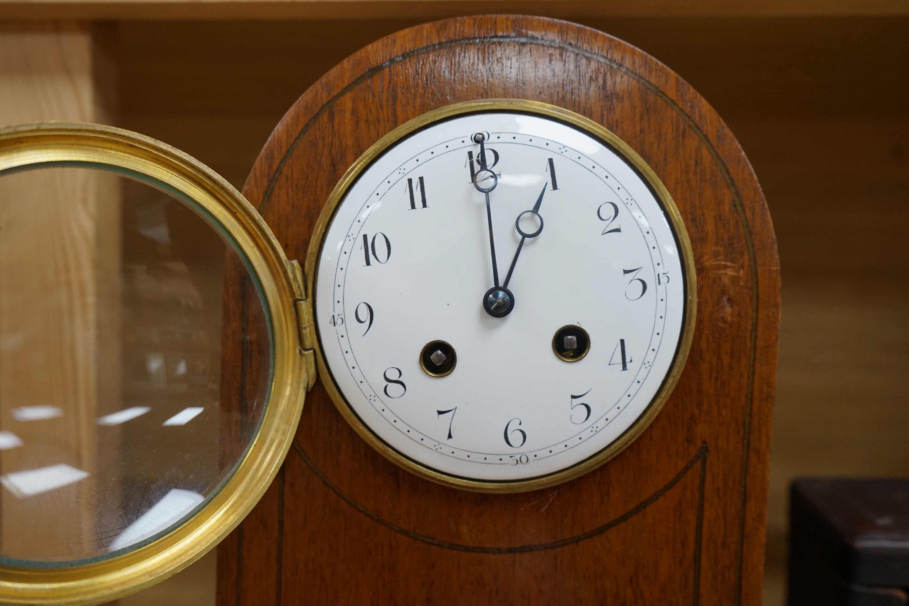 A cased brass carriage timepiece and a dome topped Edwardian mantel clock striking on a coiled gong, backplate stamped BTG, 29.5cm (2) Condition - fair to good.